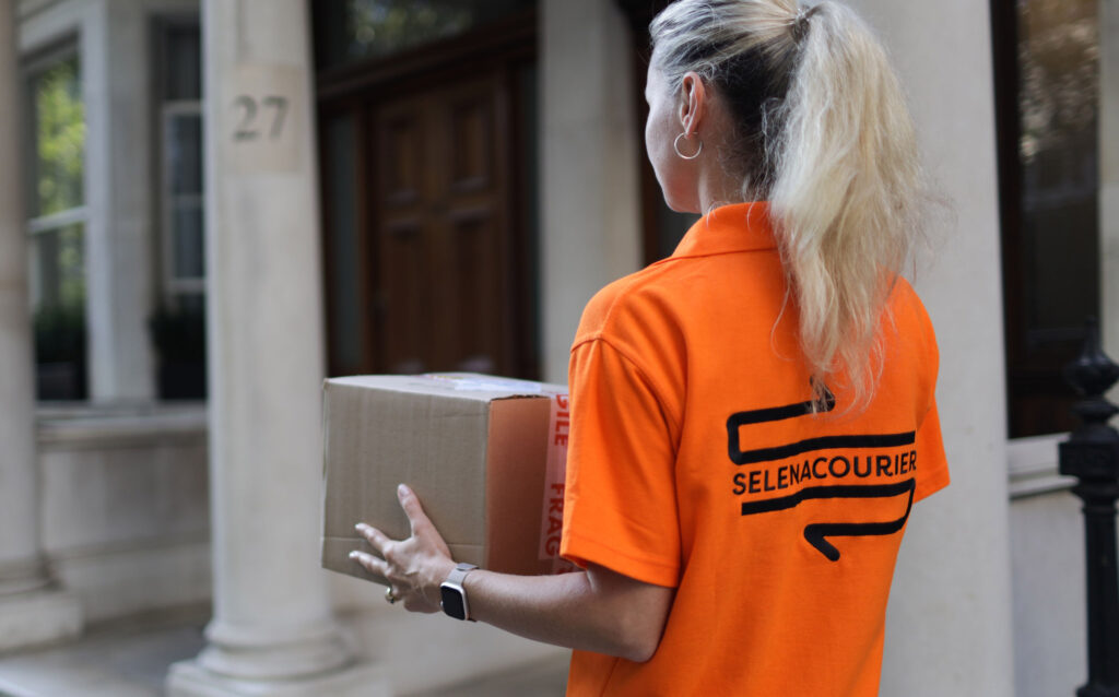 Eco-friendly courier delivering packages in London using an electric bike.