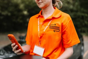 Courier checking delivery details on a phone