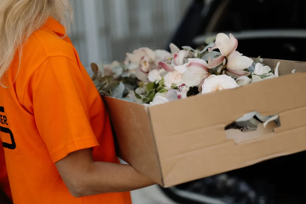 Courier delivering flowers as part of a subscription service.
