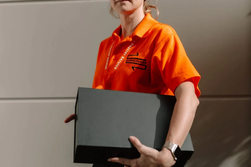 Selena courier with a black delivery box in London