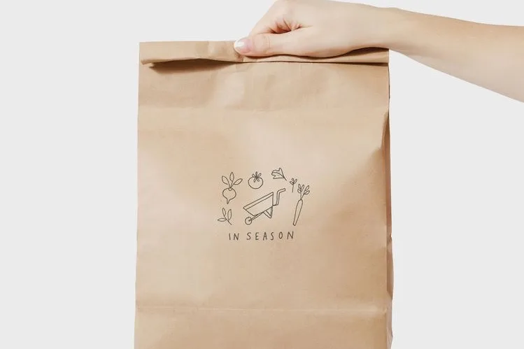 Paper takeaway bag handed over for eco-friendly delivery