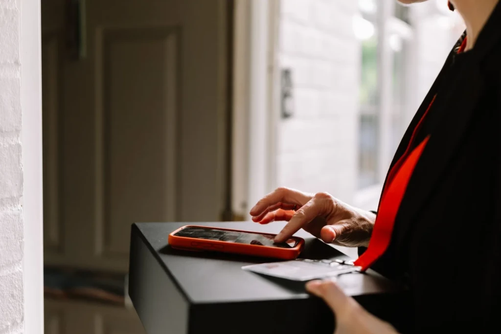 Courier confirming a doorstep delivery on a phone