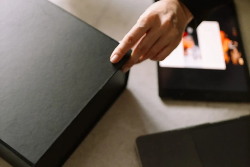 Selena Courier branded box placed beside a laptop before collection