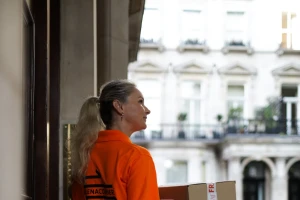 Professional white-glove courier completing a discreet handover in London