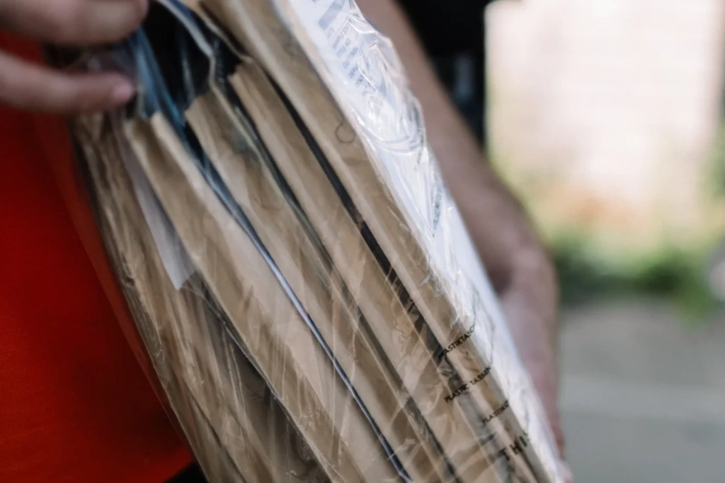 Selena courier carrying a bundle of parcels for a scheduled delivery route