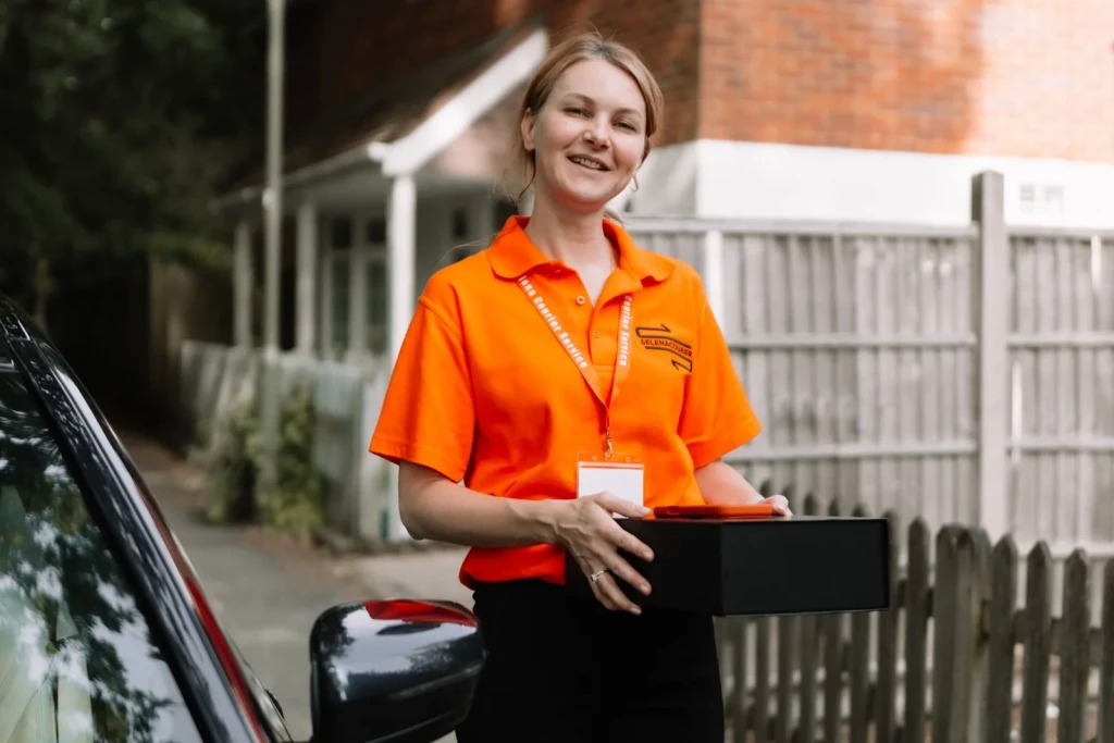 Courier stepping out of the vehicle with a client's parcel