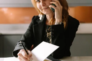 Office desk work: notes, laptop and a same-day delivery request