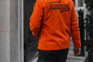 Selena courier walking to a London townhouse entrance