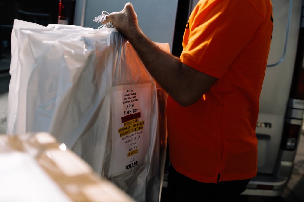 Courier delivering parcels to a London business.