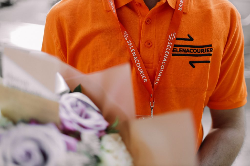 Courier delivering flowers to a customer on the same day.