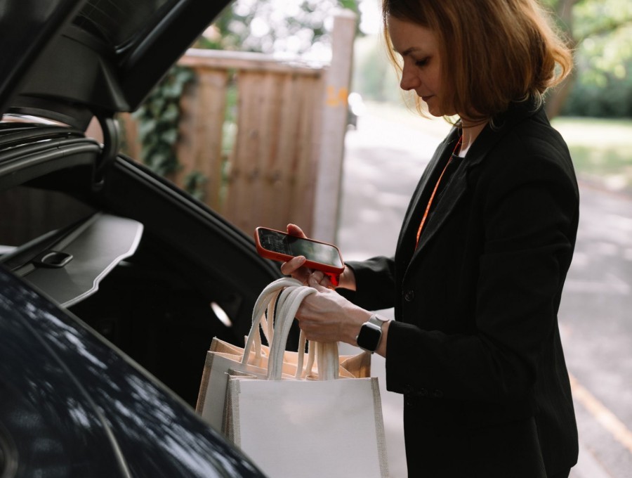 Selena courier loading prepared bags into the vehicle for a drop list